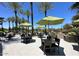 Community patio with shaded seating areas and fire pit at 12368 W Running Deer Trl, Peoria, AZ 85383