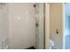 Tiled bathroom features a glass enclosed shower with decorative tile and modern fixtures at 4622 E Flower Ave, Mesa, AZ 85206