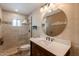 Bathroom featuring walk-in shower, tiled walls, and updated vanity area at 4622 E Flower Ave, Mesa, AZ 85206