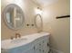 Elegant bathroom with double sinks, ornate gold faucets and fixtures, and decorative framed mirrors at 4622 E Flower Ave, Mesa, AZ 85206