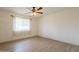 Bright bedroom featuring updated floors, a ceiling fan, and window letting in natural light at 4622 E Flower Ave, Mesa, AZ 85206