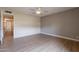 Neutral bedroom with light vinyl floors, neutral walls, a ceiling fan and plenty of space at 4622 E Flower Ave, Mesa, AZ 85206