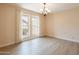 Bright dining room features wood floors, natural light from the large windows, and elegant light fixture at 4622 E Flower Ave, Mesa, AZ 85206