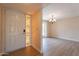 Charming front door with decorative side window leads to a spacious, well-lit dining area at 4622 E Flower Ave, Mesa, AZ 85206