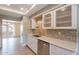 Well-lit kitchen with stone countertops, stainless steel appliances, and glass-front cabinets at 4622 E Flower Ave, Mesa, AZ 85206