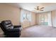 Inviting living room featuring a comfortable recliner, large window and sliding glass door to the outdoor area at 4622 E Flower Ave, Mesa, AZ 85206