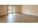 Inviting living room with wood floors, natural light, and sliding door access to the outdoors at 4622 E Flower Ave, Mesa, AZ 85206