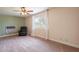 Comfortable living room featuring a ceiling fan, plush carpet, and a relaxing recliner at 4622 E Flower Ave, Mesa, AZ 85206