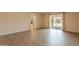 Spacious living room featuring wood floors, natural light, and direct access to the outdoor patio area at 4622 E Flower Ave, Mesa, AZ 85206