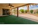 Spacious covered patio with ceiling fan, brick accents, and view of the landscaped backyard at 4622 E Flower Ave, Mesa, AZ 85206