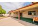 The covered patio features brick columns, a ceiling fan, and access to the landscaped backyard at 4622 E Flower Ave, Mesa, AZ 85206