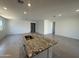 Modern kitchen island featuring granite countertops, stainless steel sink, and ample space for cooking and entertaining at 20542 N 226Th Ln, Surprise, AZ 85387
