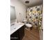 Cozy bathroom with stylish floral shower curtain and convenient towel storage at 2661 N Higley Rd, Mesa, AZ 85215