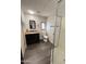 Modern bathroom featuring a vanity with drawers, a toilet, and a walk-in shower at 2661 N Higley Rd, Mesa, AZ 85215