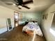 Bright bedroom featuring plush carpeting and a quaint sitting bench, adjacent to the kitchen at 2661 N Higley Rd, Mesa, AZ 85215
