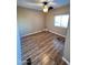 This bedroom has wood floors, a ceiling fan, and a window that lets in plenty of light at 2661 N Higley Rd, Mesa, AZ 85215