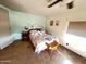 Cozy bedroom featuring a comfortable bed, ceiling fan, and a warm, inviting atmosphere at 2661 N Higley Rd, Mesa, AZ 85215