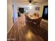 Open-concept dining and living area featuring wood-look flooring at 2661 N Higley Rd, Mesa, AZ 85215