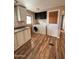 A view of the laundry area with white cabinetry and wood-look flooring at 2661 N Higley Rd, Mesa, AZ 85215