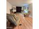 Bright living room featuring two upholstered chairs and wood-look flooring at 2661 N Higley Rd, Mesa, AZ 85215