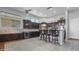 Spacious kitchen with dark wood cabinetry, island seating, and stainless steel appliances at 4276 E Meadowview Dr, Gilbert, AZ 85298
