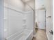 Bathroom featuring a white shower-tub combo and tile flooring at 20254 W Roma Ave, Litchfield Park, AZ 85340