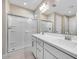 Beautiful bathroom featuring walk-in shower with glass enclosure, double vanity, and stylish fixtures at 20254 W Roma Ave, Litchfield Park, AZ 85340