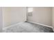 Well-lit bedroom featuring neutral tones, plush gray carpeting, and a bright window at 20254 W Roma Ave, Litchfield Park, AZ 85340