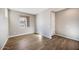 Cozy bedroom with wood-look tile flooring, a window with a neighborhood view, and neutral walls at 20254 W Roma Ave, Litchfield Park, AZ 85340