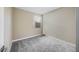 Relaxing bedroom featuring soft gray carpeting, neutral walls, and a window to allow for natural light at 20254 W Roma Ave, Litchfield Park, AZ 85340