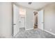 Inviting bedroom with walk-in closet and ensuite bathroom entry, featuring soft gray carpet and neutral walls at 20254 W Roma Ave, Litchfield Park, AZ 85340