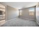 Comfortable bedroom featuring soft gray carpet, neutral walls, and easy access to the ensuite bathroom at 20254 W Roma Ave, Litchfield Park, AZ 85340