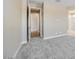 Inviting bedroom with neutral colors, plush gray carpeting, and easy access to ensuite bathroom and walk-in closet at 20254 W Roma Ave, Litchfield Park, AZ 85340