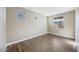 Cozy bedroom with wood-look tile flooring and several windows allowing for plenty of natural light at 20254 W Roma Ave, Litchfield Park, AZ 85340