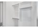 Closet with white shelves, rods, and ample storage space at 20254 W Roma Ave, Litchfield Park, AZ 85340