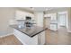 Bright kitchen showcasing a center island, white cabinetry, and modern finishes at 20254 W Roma Ave, Litchfield Park, AZ 85340