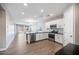 Modern kitchen featuring stainless steel appliances, white cabinets, and an open layout at 20254 W Roma Ave, Litchfield Park, AZ 85340