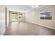 Bright living room features wood-look tile flooring, recessed lighting, and sliding glass door to the backyard at 20254 W Roma Ave, Litchfield Park, AZ 85340