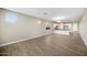 Spacious living room with wood-look tile floors, neutral walls, and plenty of natural light at 20254 W Roma Ave, Litchfield Park, AZ 85340