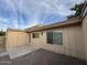 Backyard with neutral home, small patio area, rock landscaping, and blue skies with light clouds at 2142 E Donner Dr, Tempe, AZ 85282