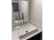 Bathroom vanity featuring a modern sink with a chrome faucet, a mirror, and a gray storage cabinet at 2142 E Donner Dr, Tempe, AZ 85282