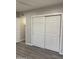 Bedroom closet with sliding doors, white trim and gray-tone flooring at 2142 E Donner Dr, Tempe, AZ 85282