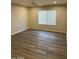 This bedroom has wood laminate flooring, a ceiling fan, and a window with horizontal blinds at 2142 E Donner Dr, Tempe, AZ 85282