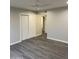 This bedroom has wood laminate flooring and a ceiling fan, with access to closets and other rooms at 2142 E Donner Dr, Tempe, AZ 85282