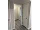 Bright hallway featuring modern lighting and stylish gray wood flooring at 2142 E Donner Dr, Tempe, AZ 85282