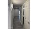 Hallway showcases open sightlines with bathroom access and matching gray-tone flooring at 2142 E Donner Dr, Tempe, AZ 85282
