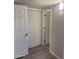 View of the hallway featuring modern lighting, bi-fold closet doors, and wood laminate flooring at 2142 E Donner Dr, Tempe, AZ 85282