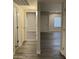 Hallway showcases open sightlines with doors, neutral wall paint, and matching gray-tone flooring at 2142 E Donner Dr, Tempe, AZ 85282