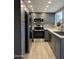 Updated kitchen with stainless steel appliances, gray cabinets, subway tile backsplash, and a modern sink at 2142 E Donner Dr, Tempe, AZ 85282
