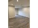 Spacious living room with modern recessed lighting and stylish gray wood flooring at 2142 E Donner Dr, Tempe, AZ 85282